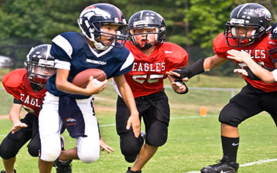 A group of young kids playing football together