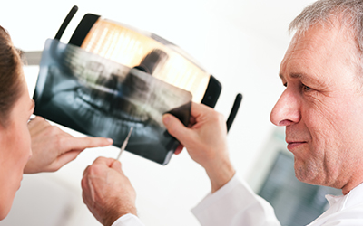 Male dentist explaining an x-ray up-close