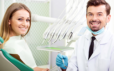 Child sitting in a dental chair with the dentist smiling