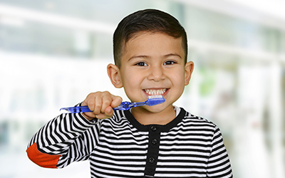 A young boy brushing his teeth